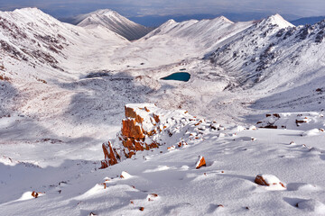 Epic morning view of a mountain valley with moraine lakes after an overnight snowfall; the first...