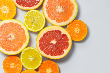 Fototapeta na wymiar Sliced citrus on a white background. Grapefruit, lemon, tangerine.