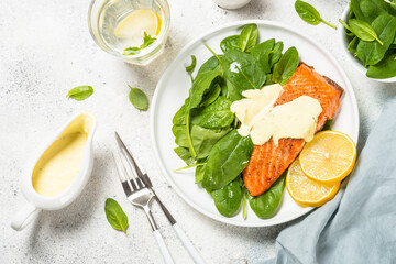 Salmon fillet with fresh salad and yogurt dressing. Healthy food, keto diet. Healthy lunch or dinner. Top view at white.