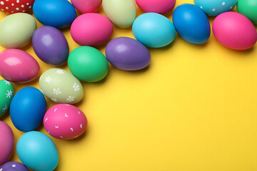 Bright painted eggs on yellow background, flat lay with space for text. Happy Easter