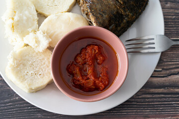 Nigerian boiled yam served with Grilled fish and tomato pepper sauce
