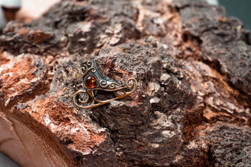 Bronze decoration in the form of skates on a wooden background close-up