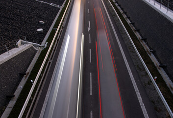 Cars lights driving on the evening road. Top view of traffic on a road corridor.