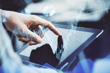 Multi exposure of man's hands holding and using a phone and financial chart drawing. Market analysis concept.