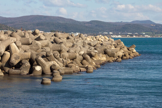 Tetrapod wave breaker,concrete tetrapods on the beach 
,concrete construction at Marina of Santa Marinella.Italy.