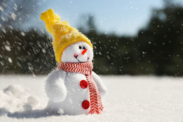 Cute small decorative snowman outdoors on winter day, space for text