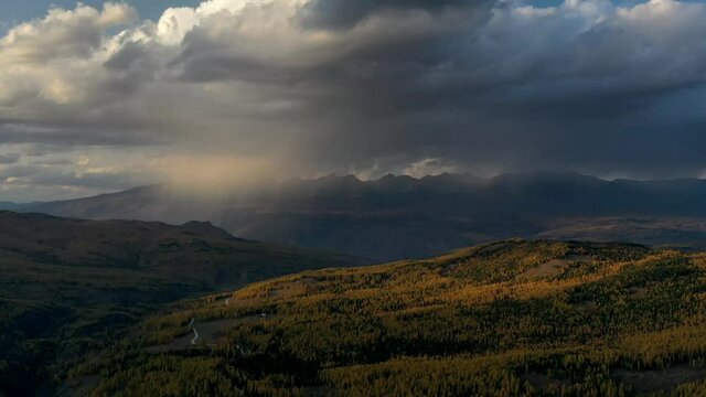 Air wide shot of sunset and epic rain clouds over the mountains time lapse