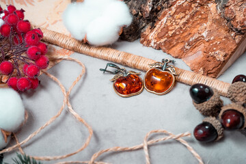 A pair of amber and bronze earrings. View from above