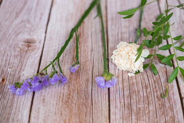 The florist desktop on light wooden background with copy space.