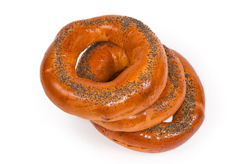 Stacked poppy seed ring-shaped bread rolls on white background