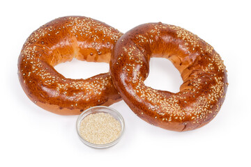 Ring shaped bread rolls sprinkled with sesame and separately sesame