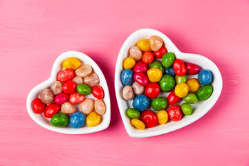 Multicolored candies in a plate in the shape of a heart