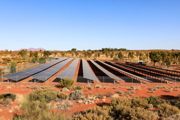 Solar panel field in Australian outback beneath blue sky