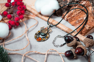 Beetle of bronze and resin against the background of gray fabric