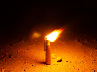 Flame from homemade gasoline lighter in the night