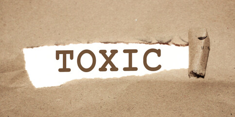Toxic word uner Brown torn paper with yellow background. Addictions, quit smoking and drinking, bad...