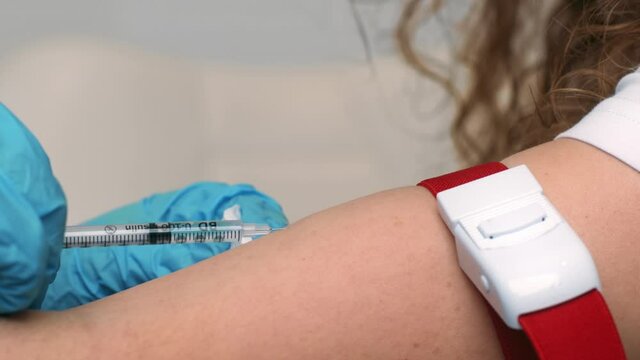Insulin injection. Close up shot of doctor hands in medical gloves injecting diabetic woman with meds