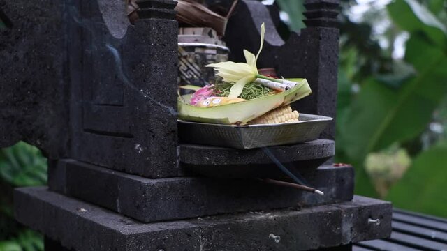 Balinese Hindu offerings Canang Sari Traditional offerings to gods and spirits with flowers, food, and smoky aromatic sticks