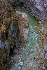 beautiful landscape with a mountain river with small waterfalls in winter day in the canyon.
