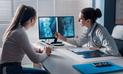 Doctor checking a patient's x-ray of spine