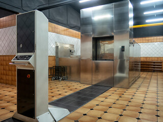 room in a crematorium with a modern stainless steel oven - 415764454