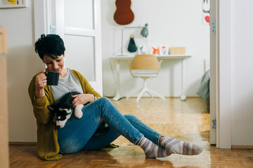 woman enjoying time with her husky at home © cherryandbees
