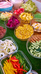Bowls of fresh fruits and vegetables on salad store display