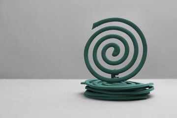 New insect repellent coils on grey background Space for text