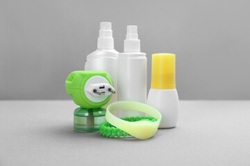 Set of different insect repellents on grey background