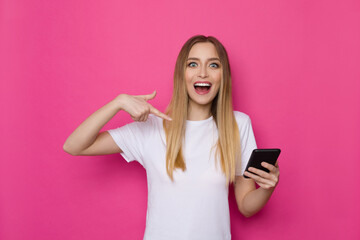 Naklejka premium Happy Young Woman Is Pointing At Telephone And Shouting