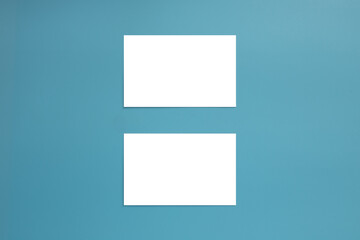 Mockup of two white business cards on a blue background. Template with space for text.