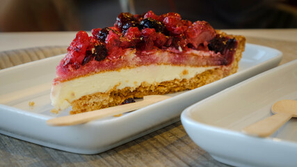 Typical swedish cheesecake with strawberries blackberries blueberries closeup selective focus