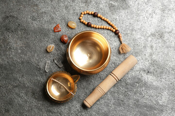 Obraz na płótnie Canvas Flat lay composition with golden singing bowl on grey table. Sound healing