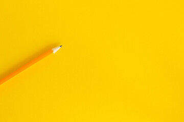 Black pen, pencil and brush on yellow background