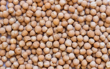 Background of dry chickpeas of lamb or Turkish peas close-up. The texture of the dried chickpeas or garbanzo chickpeas
