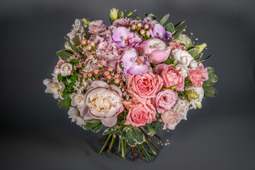 Close up wedding bouquet of flowers Isolated on a gray background. Delicate bouquet in pastel colors. Summer flowers