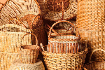 Many different wicker baskets made of natural material as background