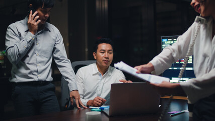 Collaborative process of multicultural businesspeople using laptop presentation and communication meeting brainstorming ideas about new project colleagues working plan success strategy in night office