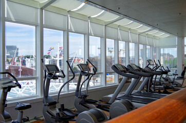 Fitness Center or gym onboard luxury cruiseship or cruise ship liner with modern cardio and free...