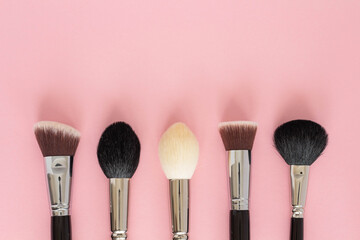 Set of large cosmetic brushes on pink background
