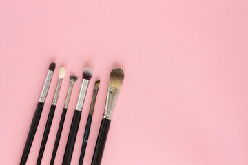 Set of large cosmetic brushes on pink background