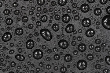 Water drops on black background texture. Dark backdrop glass covered with drops of water. gray bubbles in water