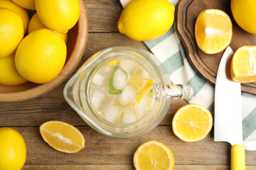 Cool freshly made lemonade and fruits on wooden table, flat lay