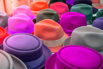 multi-colored hats of different styles on the store counter blurred background