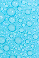 Water drops on blue background texture. Backdrop glass covered with drops of water. bubbles in water
