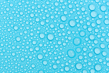 Water drops on blue background texture. Backdrop glass covered with drops of water. bubbles in water