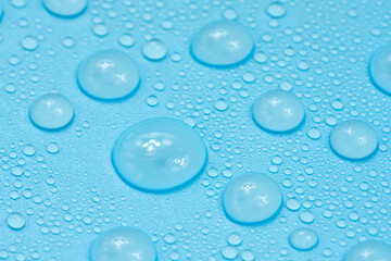 Water drops on blue background texture. Backdrop glass covered with drops of water. bubbles in water