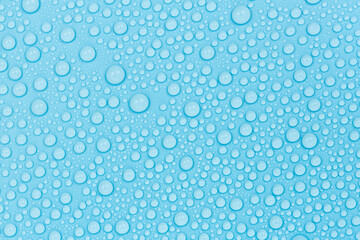 Water drops on blue background texture. Backdrop glass covered with drops of water. bubbles in water