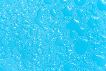 Water drops on blue background texture. Backdrop glass covered with drops of water. bubbles in water