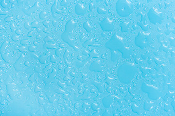 Water drops on blue background texture. Backdrop glass covered with drops of water. bubbles in water